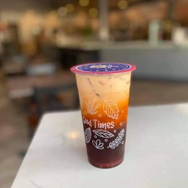 A colorful layered drink from Boba Pho U, with dark red, orange, and creamy white layers.
