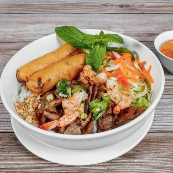 Boba Pho U's Vietnamese vermicelli bowl with grilled pork, shrimp, egg rolls, and fresh vegetables.